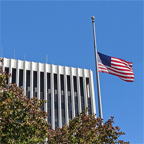 United State's flag flown at half-staff in front of City Hall