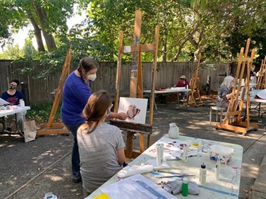 Painting instructor teaching outdoors
