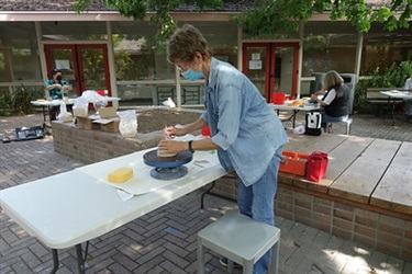 Students in the Art Center outdoor ceramics studio
