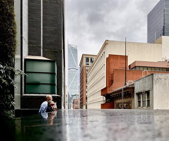 photograph of urban landscape two figures looking up