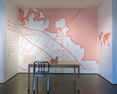 A pink and white map of Palo Alto and East Palo Alto in a nook area with a table and chair