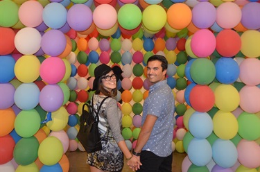image of couple in front of giant balloon castle
