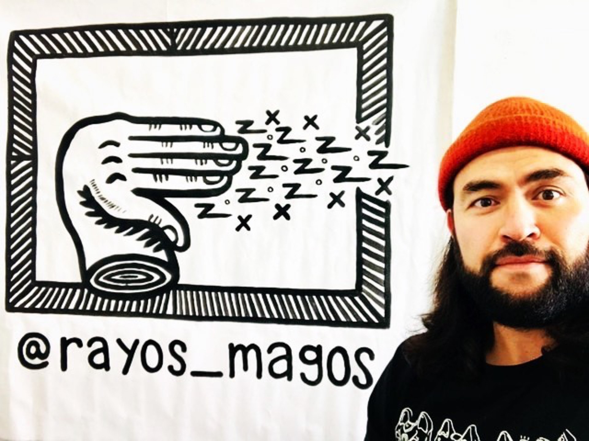 Rayos Magos next to one of his artworks