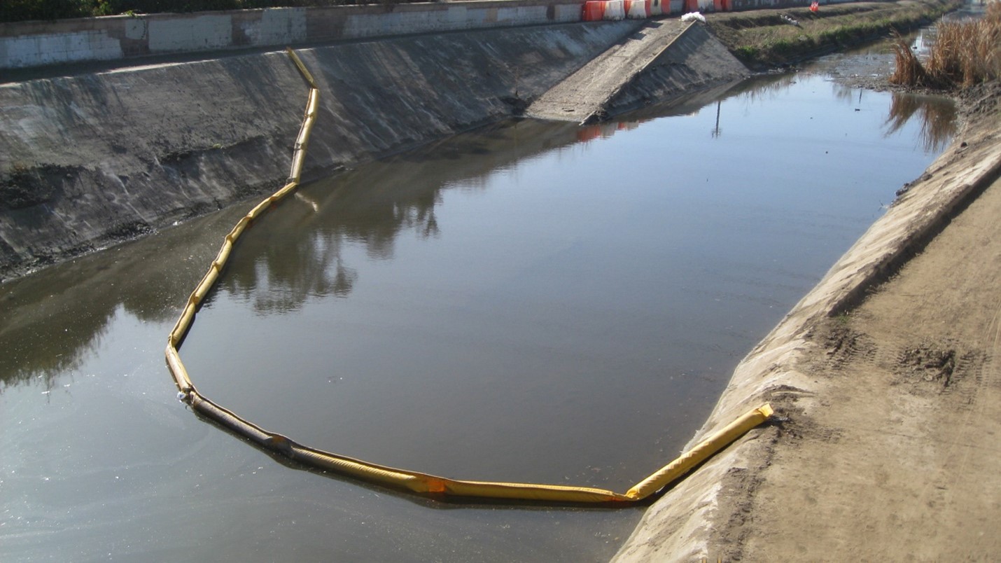 Trash boom deployed in Matadero Creek safely anchored in concrete walls