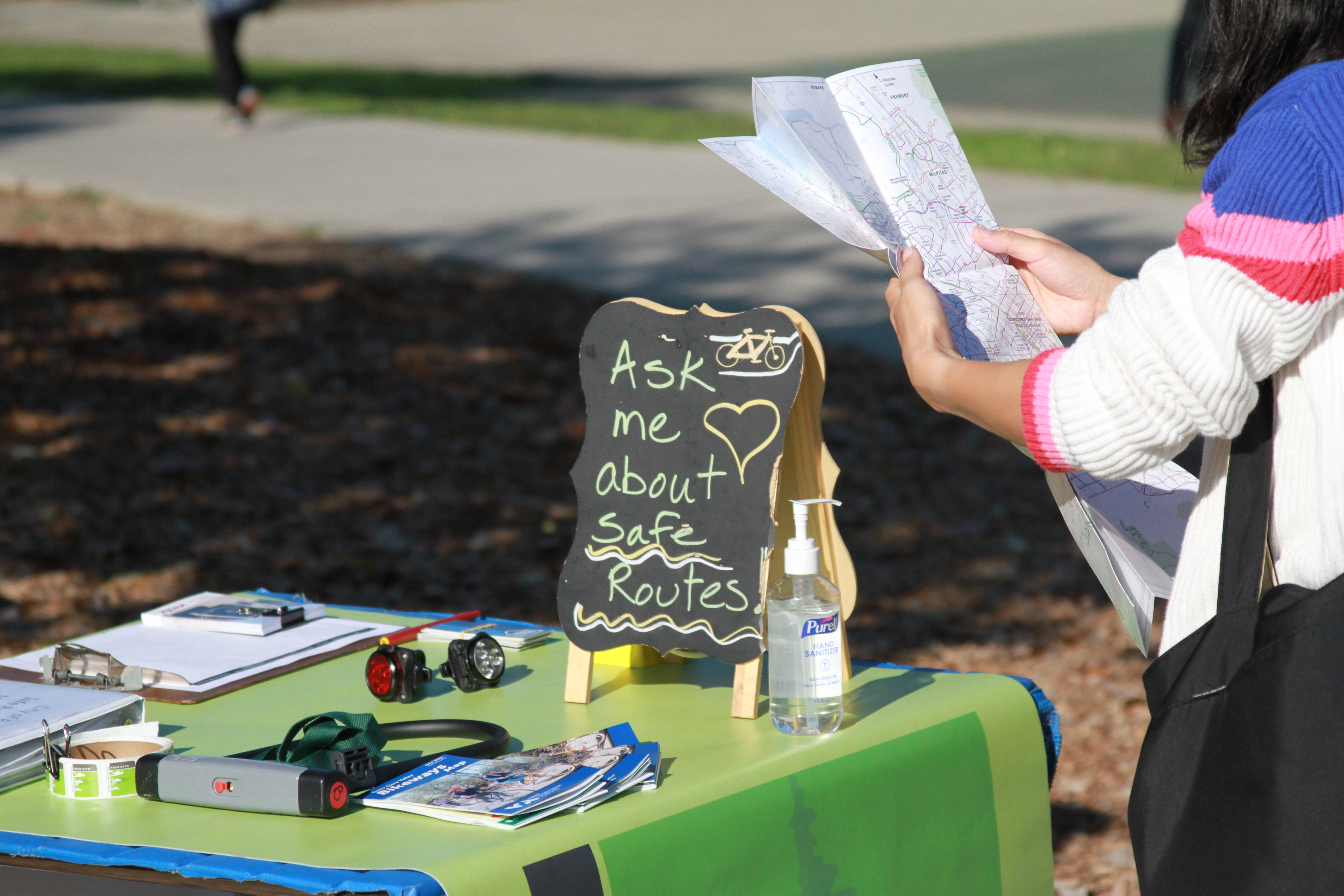 A woman holds a map in front of the MIKE pop-up
