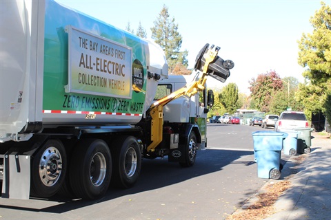 GreenWaste's  all electric collection truck picking up waste can for collection
