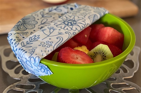 Beeswax wrap around bowl of fruit