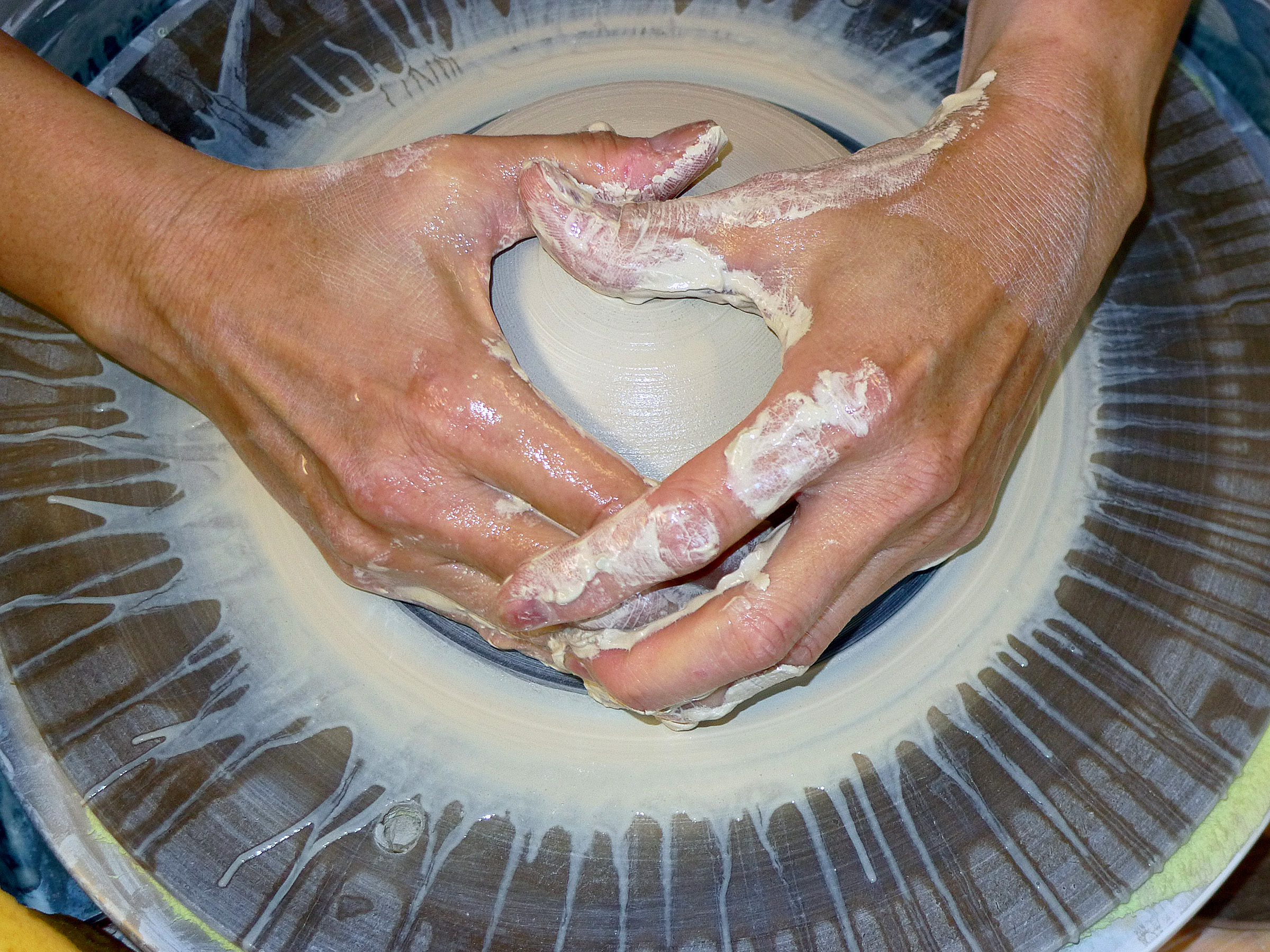 image of hands on potters wheel