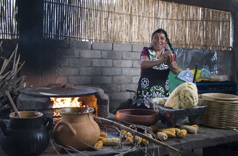 Oaxacan chef prepares a meal on an open flame